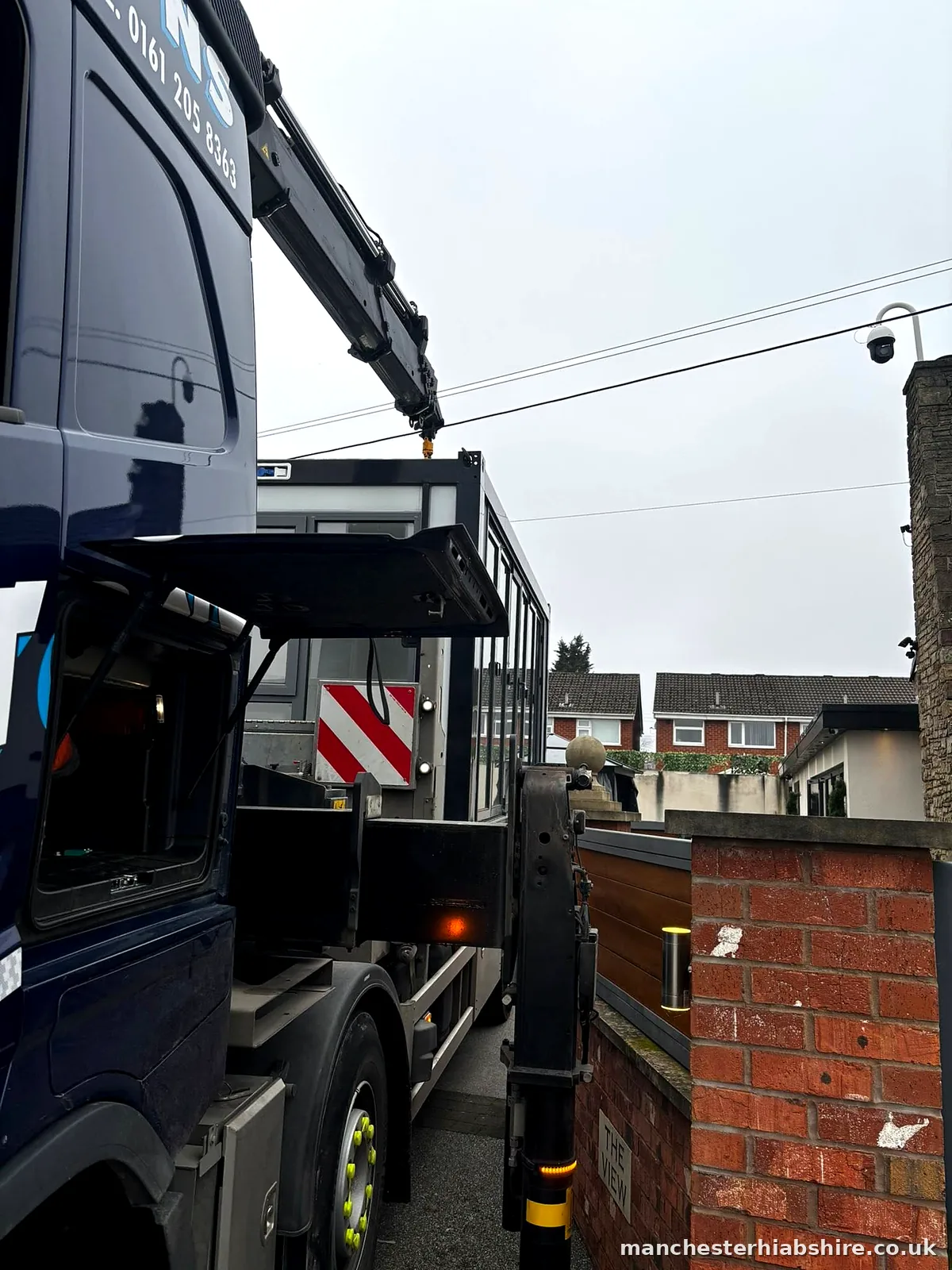 HIAB lorry working in a tight street