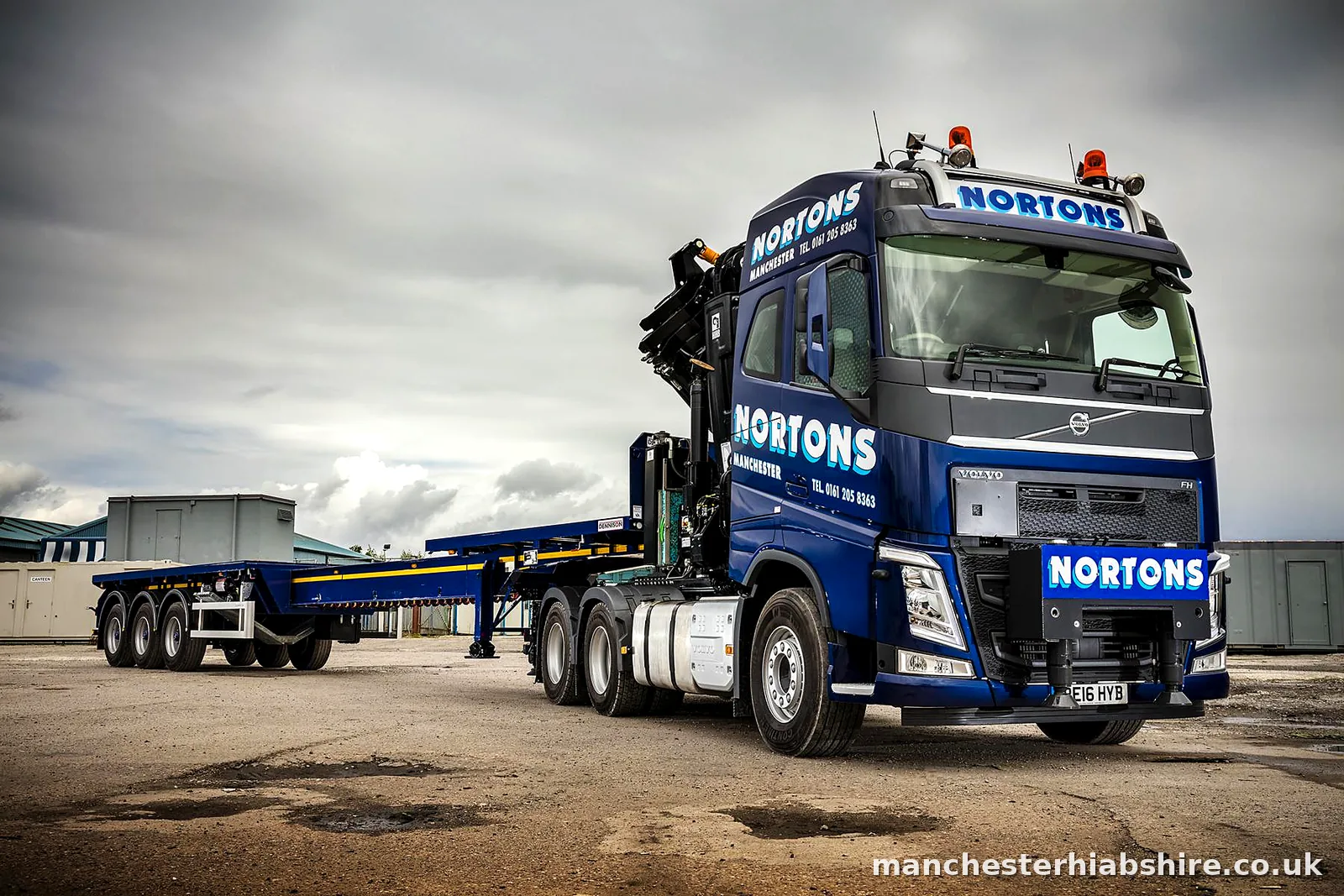 Articulated HIAB tractor unit with a four axle extendable trailer fully extended