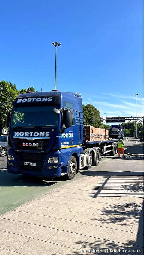 Flatbed loaded with wrapped packs of bricks