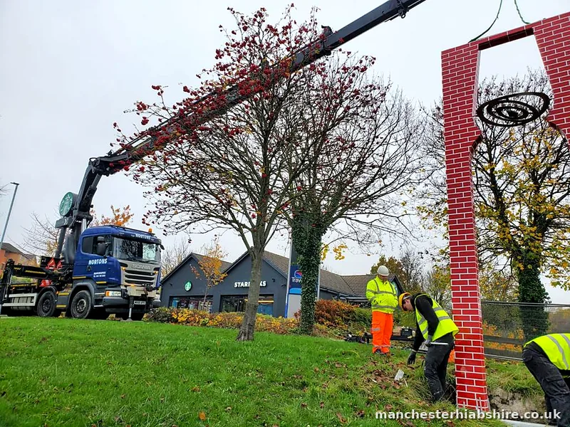 Entrance sign lowered into position on the HIAB