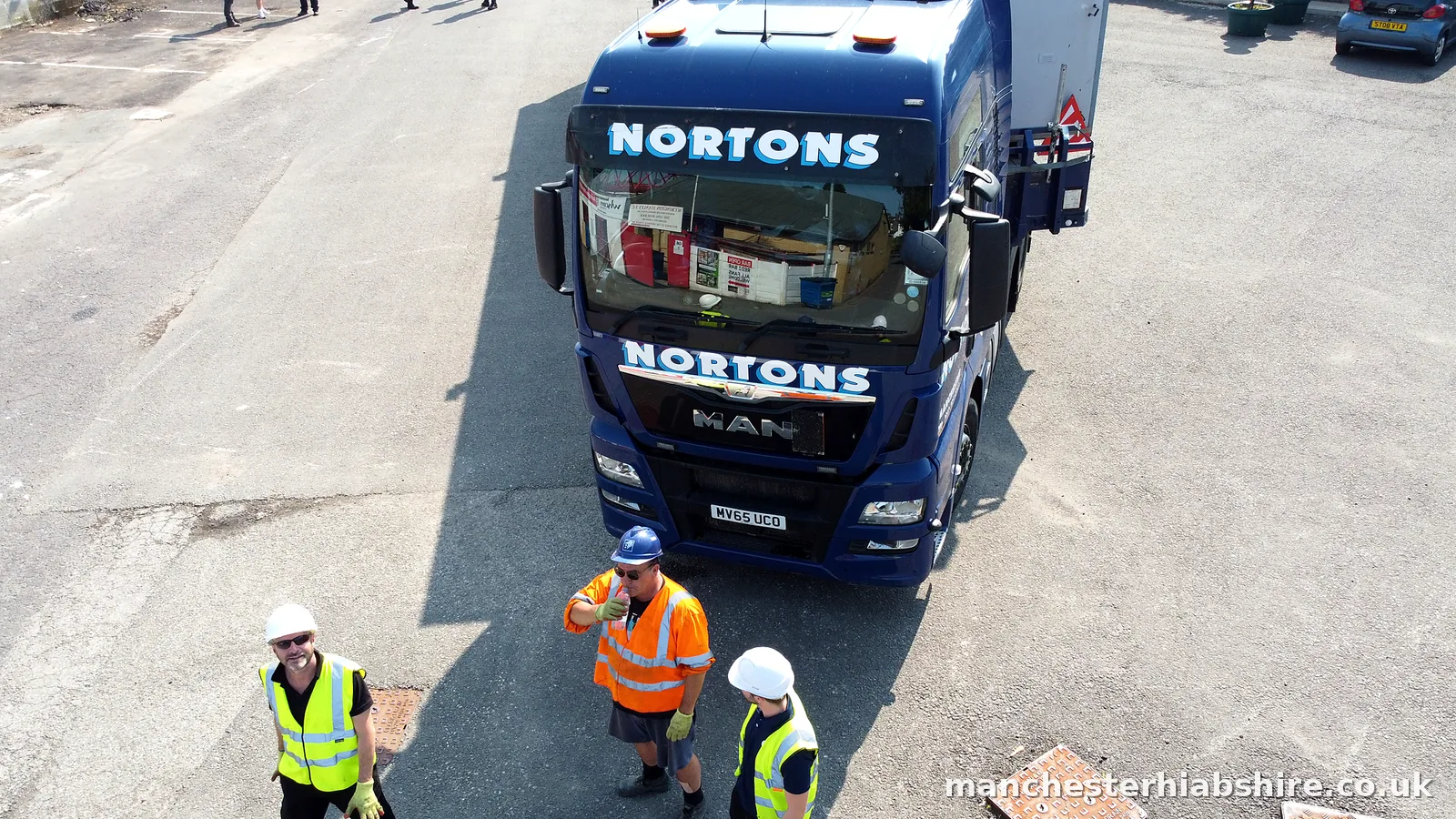 Overhead view of the lorry with three crew on site in full protective equipment