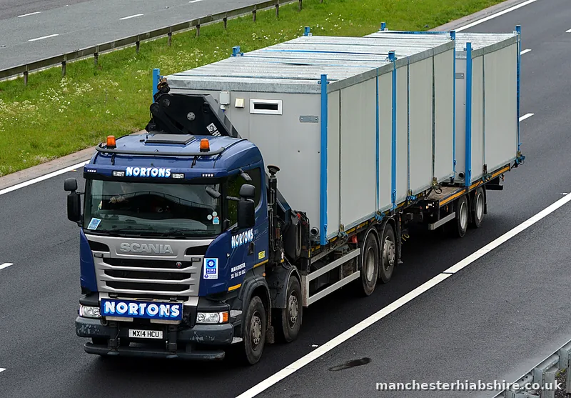HIAB lorry and trailer carrying two long cabin units on a northbound motorway