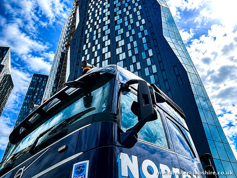 HIAB lorry working beside a high rise building in Manchester city centre