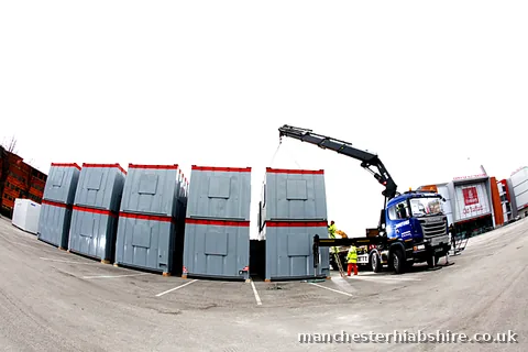 Modular units stacked with crew working alongside at Emirates Old Trafford