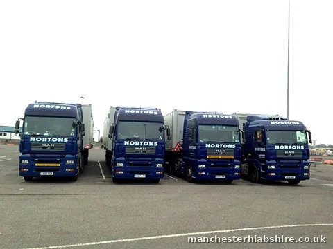 Four HIAB lorries lined up nose out waiting to unload