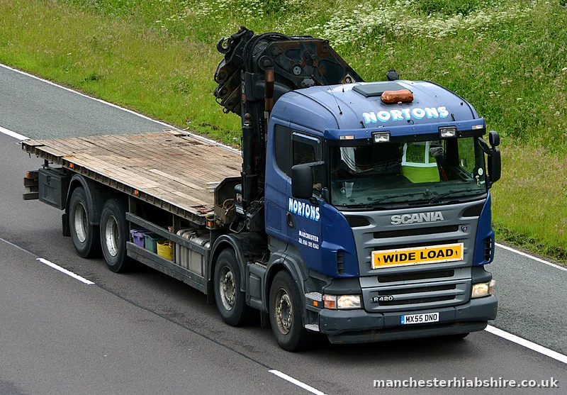 HIAB outfit with a wide load board and an empty flat trailer