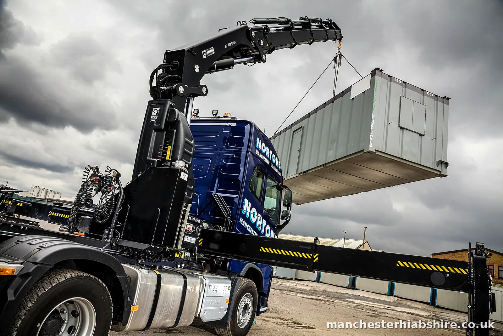 Looking up the lorry mounted crane column from the bed with the load suspended