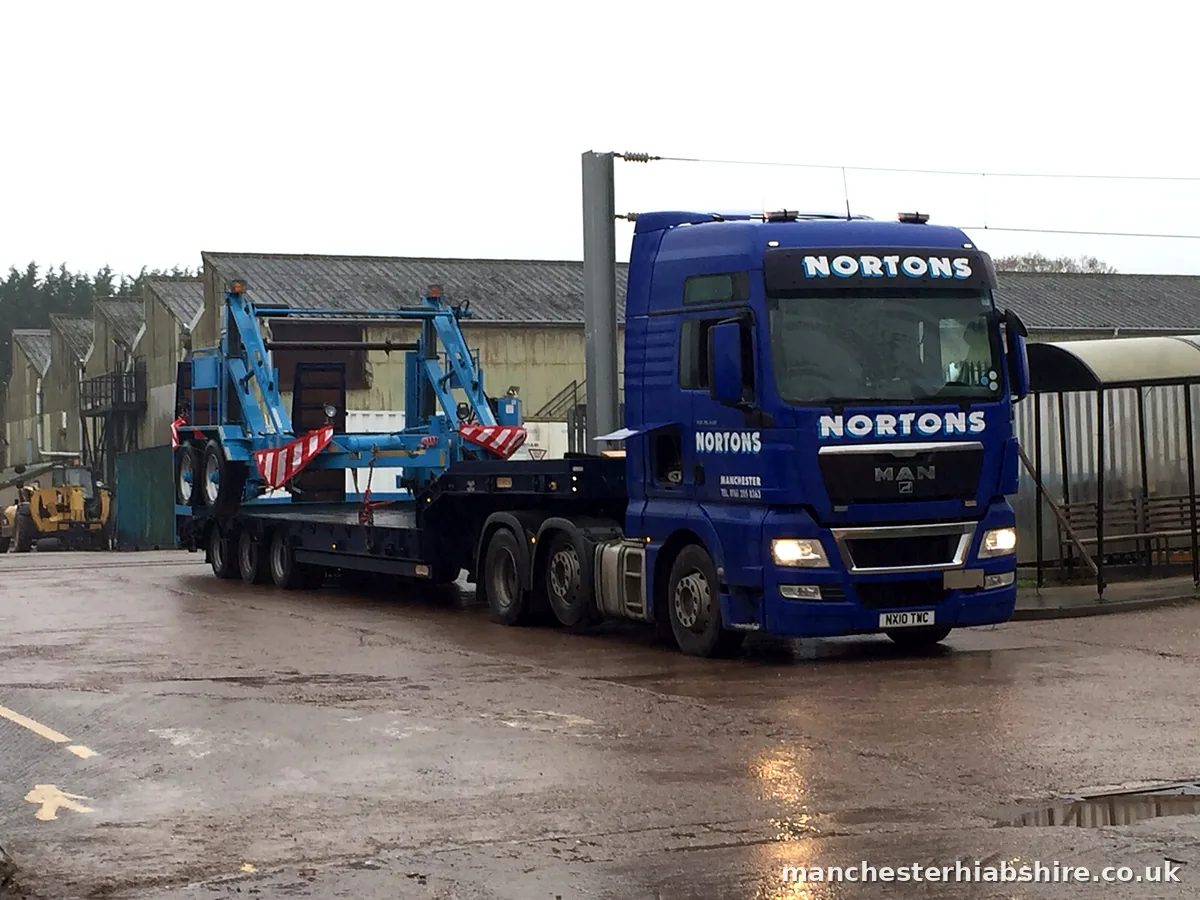 Low loader carrying an industrial machine secured for the road