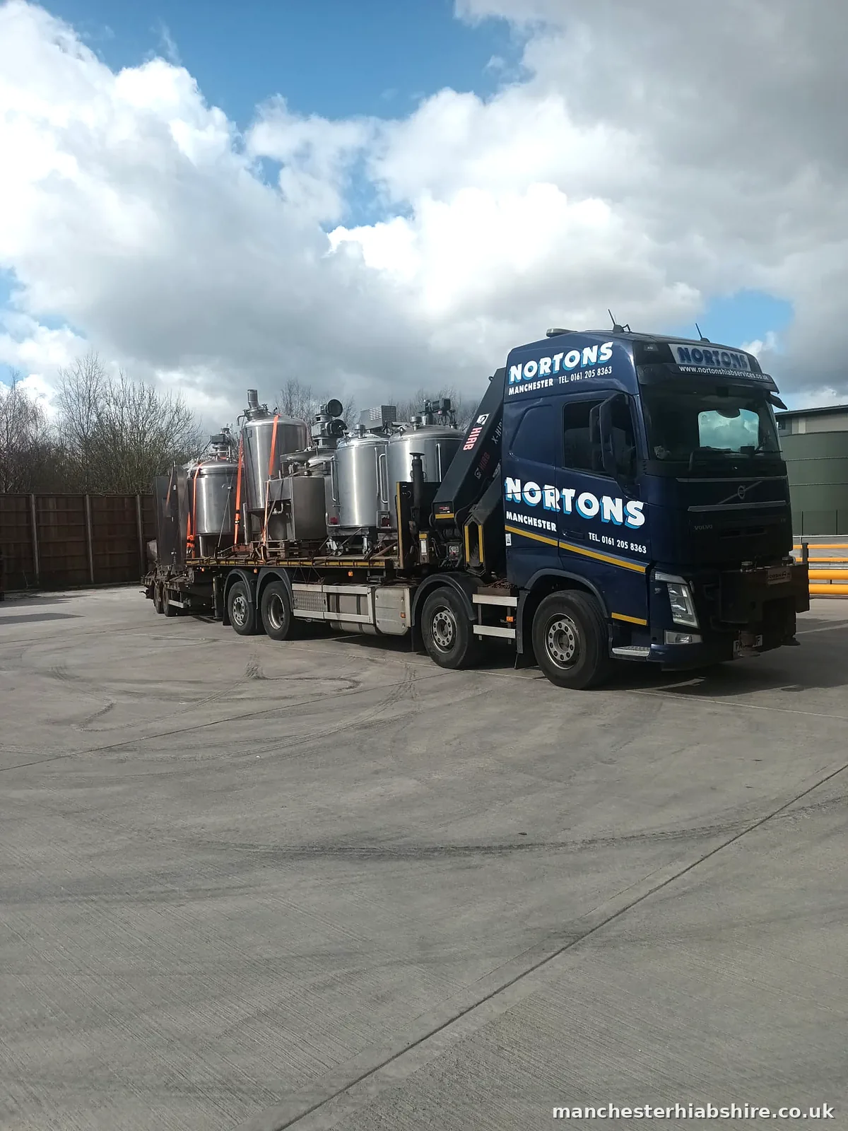Lorry and trailer loaded with stainless steel process vessels