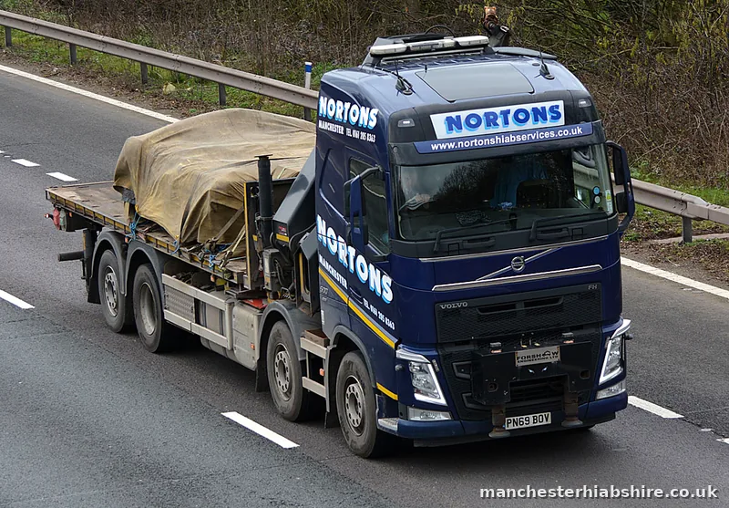 Sheeted load strapped down on a HIAB lorry flat bed