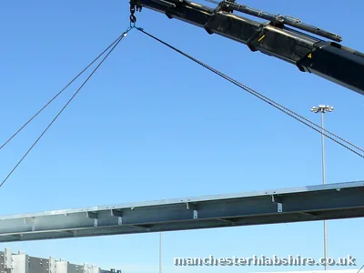 HIAB lorry crane lifting a galvanised steel beam at Manchester Airport
