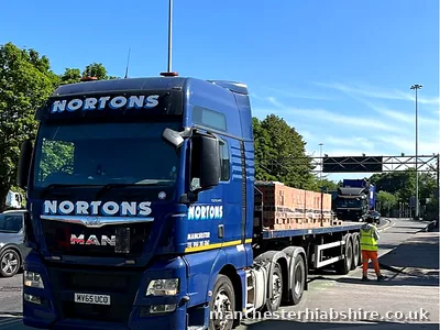 Flatbed loaded with wrapped packs of bricks