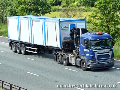 Cabin units strapped on an articulated HIAB trailer