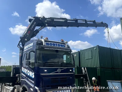 HIAB boom extended with the chain hook above stacked shipping containers