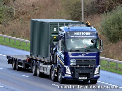HIAB lorry and trailer carrying a shipping container on the motorway