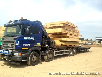 Eight wheel lorry and trailer loaded with engineered timber beams