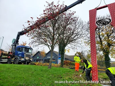Entrance sign lowered into position on the HIAB