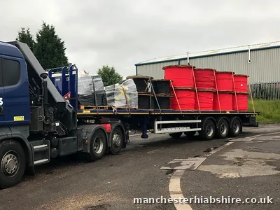 Flatbed trailer loaded with cable drums and palletised goods