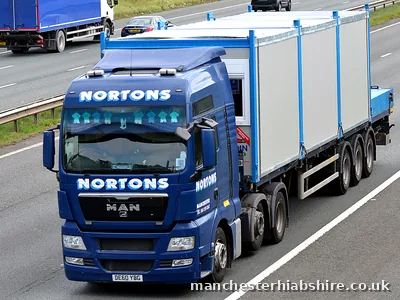 Two site cabins carried side by side on a HIAB trailer