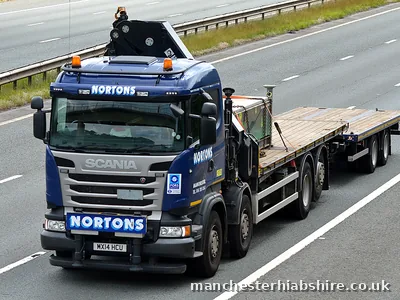 Empty HIAB flatbed lorry running on the motorway