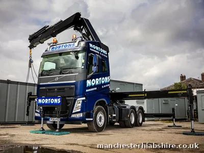 HIAB lorry with the lorry mounted crane raised and outriggers deployed, three quarter view