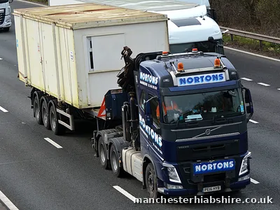 HIAB lorry and trailer carrying a wide modular unit on the motorway