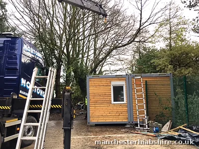 Timber clad modular unit placed on site with the HIAB lorry behind
