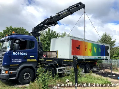 Painted cabin with an animal silhouette mural lifted on the HIAB