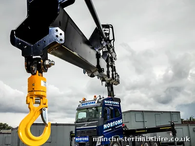 Low angle view of the hook block and lifting beam with the lorry behind
