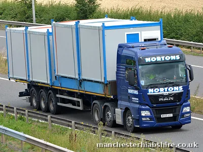 HIAB lorry and trailer carrying cabin units on the motorway