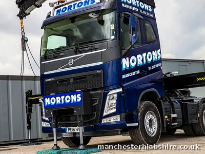 HIAB lorry front three quarter view in the yard after rain