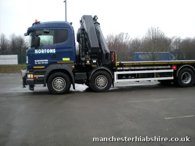 Rigid HIAB lorry with an empty flat bed and the boom stowed