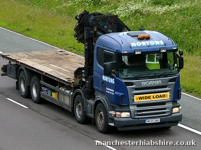 HIAB outfit with a wide load board and an empty flat trailer