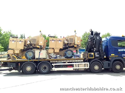 Industrial equipment loaded along the flat bed of a HIAB lorry
