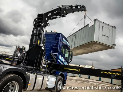 Looking up the lorry mounted crane column from the bed with the load suspended