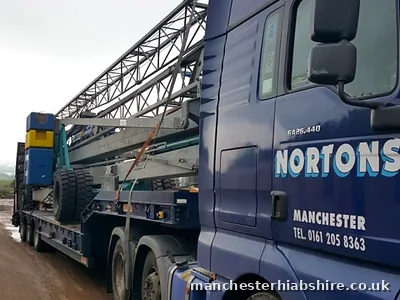 Low loader carrying dismantled lattice boom sections