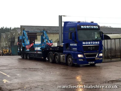 Low loader carrying an industrial machine secured for the road