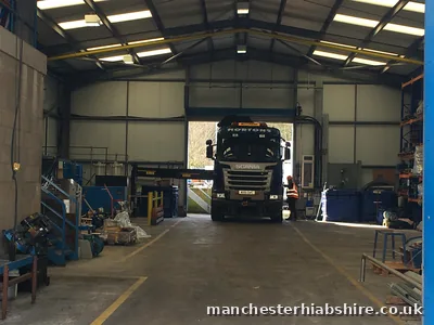 HIAB lorry reversed into a workshop doorway with outriggers deployed