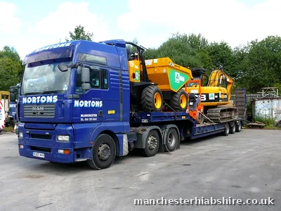 Low loader carrying a site dumper and a tracked excavator