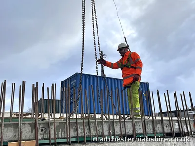 Precast concrete plank being landed onto timber bearers on the trailer