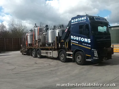 Lorry and trailer loaded with stainless steel process vessels