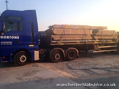 Loaded scaffold trailer of boards, tube and bagged fittings in low sun