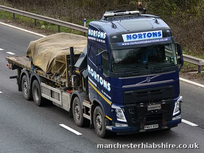 Sheeted load strapped down on a HIAB lorry flat bed