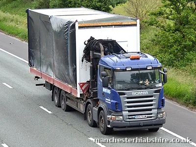 Sheeted and strapped load carried on a HIAB lorry