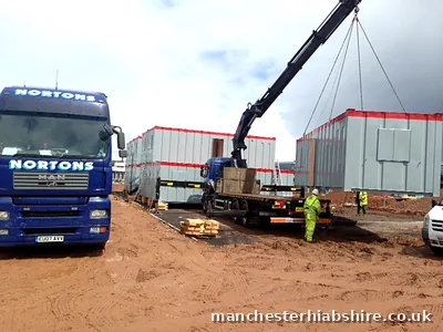 Modular cabin set into position by the HIAB with crew in protective equipment