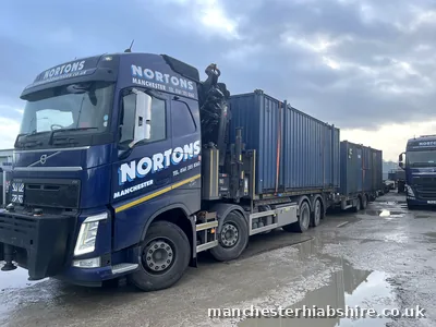 Shipping container on the lorry bed and a second container on the trailer