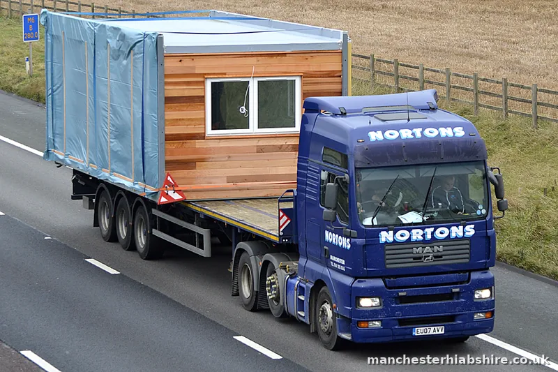 Timber clad pod wrapped and strapped on a HIAB trailer